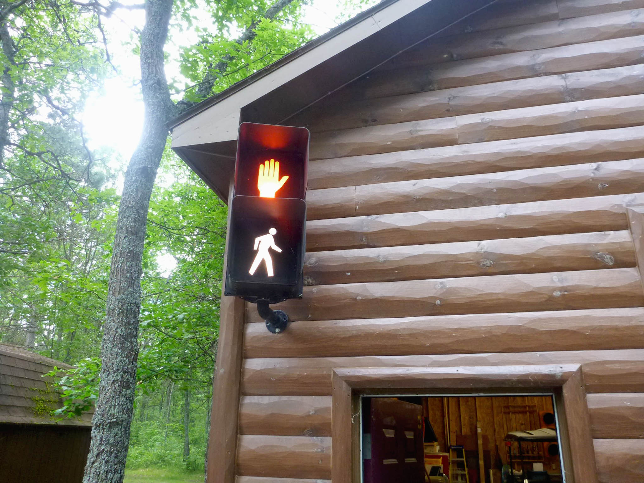 Walk and don't walk signal on the side of a house.